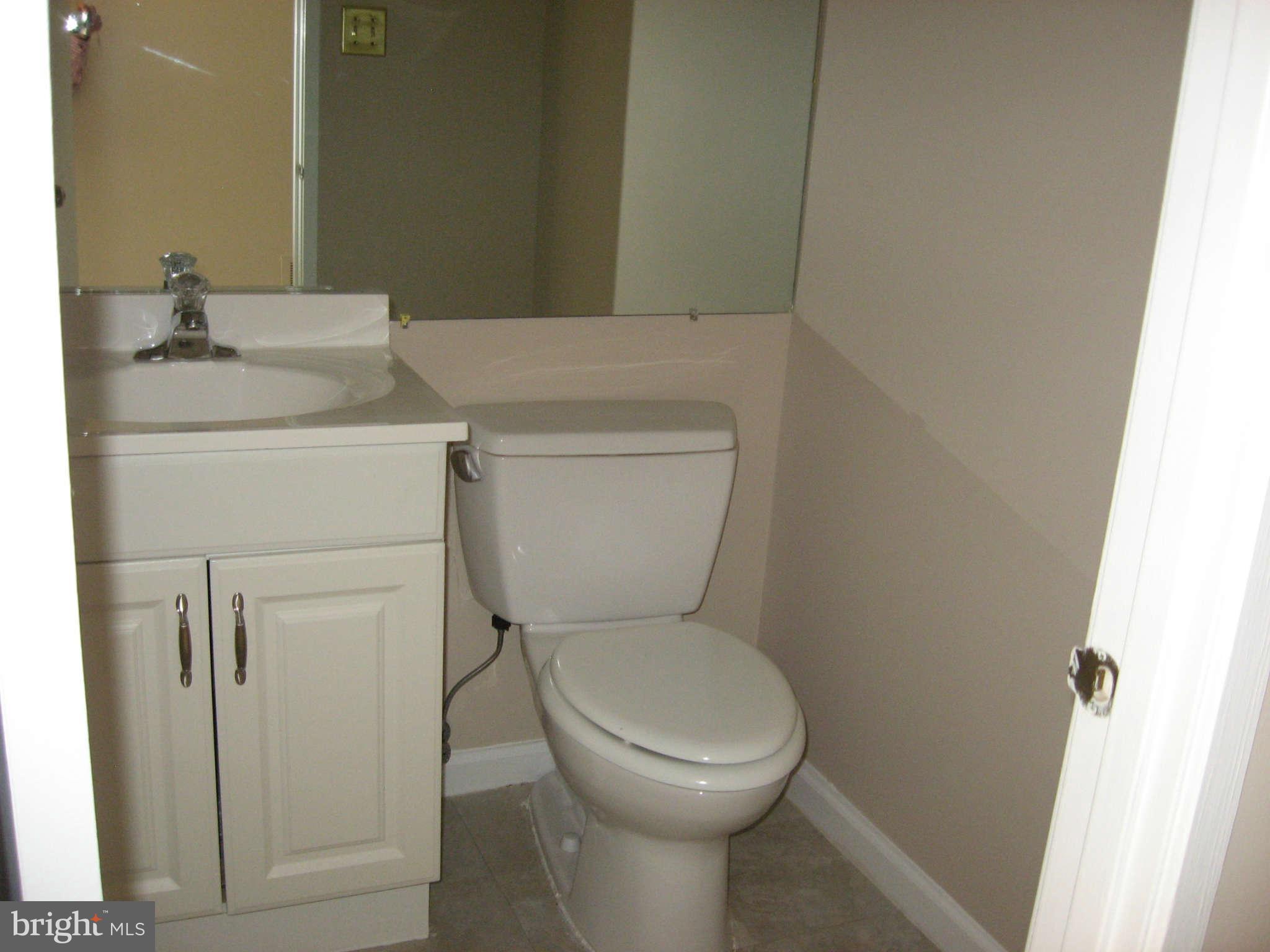 2356 Hunters Square Court, Unit 2356 Reston, VA 20191 - Photo 6 of 27 a bathroom with a toilet sink and vanity
