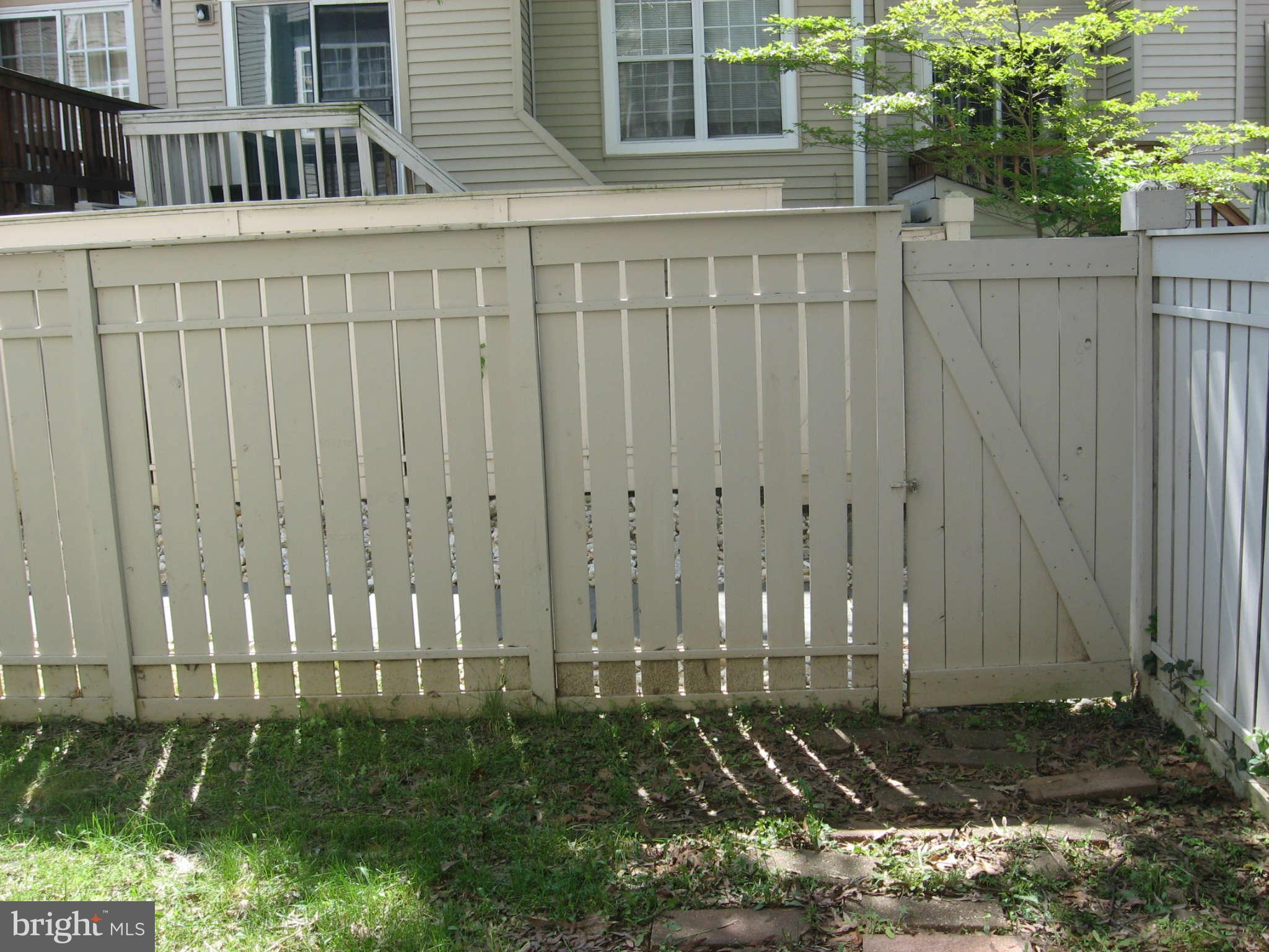 2356 Hunters Square Court, Unit 2356 Reston, VA 20191 - Photo 10 of 27 a view of a house with a wooden fence