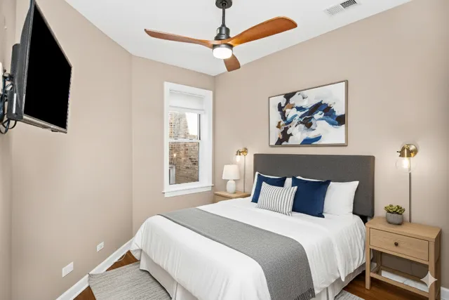 a bedroom with a bed and a flat screen tv