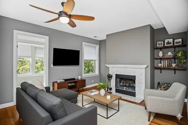 a living room with furniture a flat screen tv and a fireplace