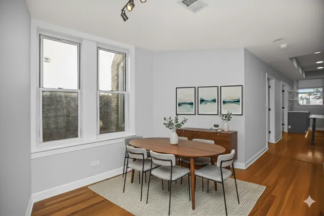 a view of a dining room with furniture and wooden floor