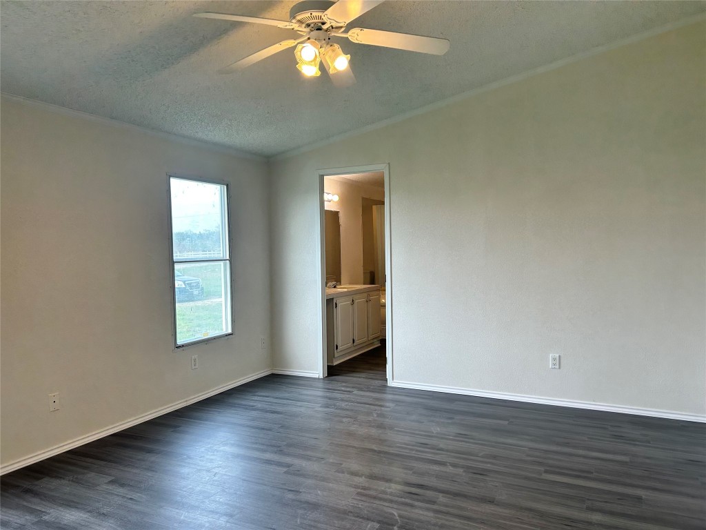 109 Appaloosa Way Kyle, TX 78640 - Photo 5 of 11 an empty room with wooden floor and windows