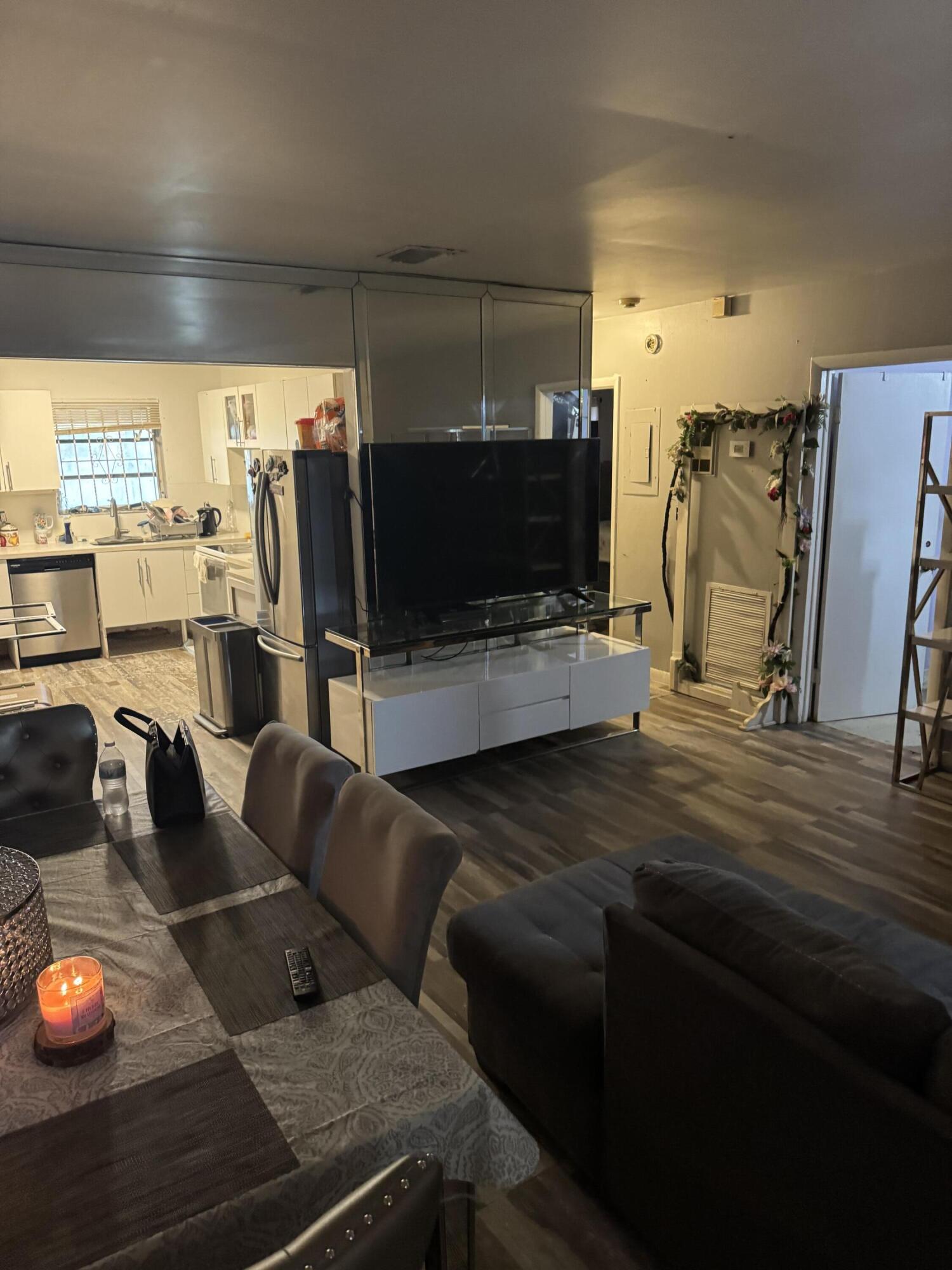 1017 Northwest 47th Street Miami, FL 33127 - Photo 2 of 18 a living room with furniture and a flat screen tv