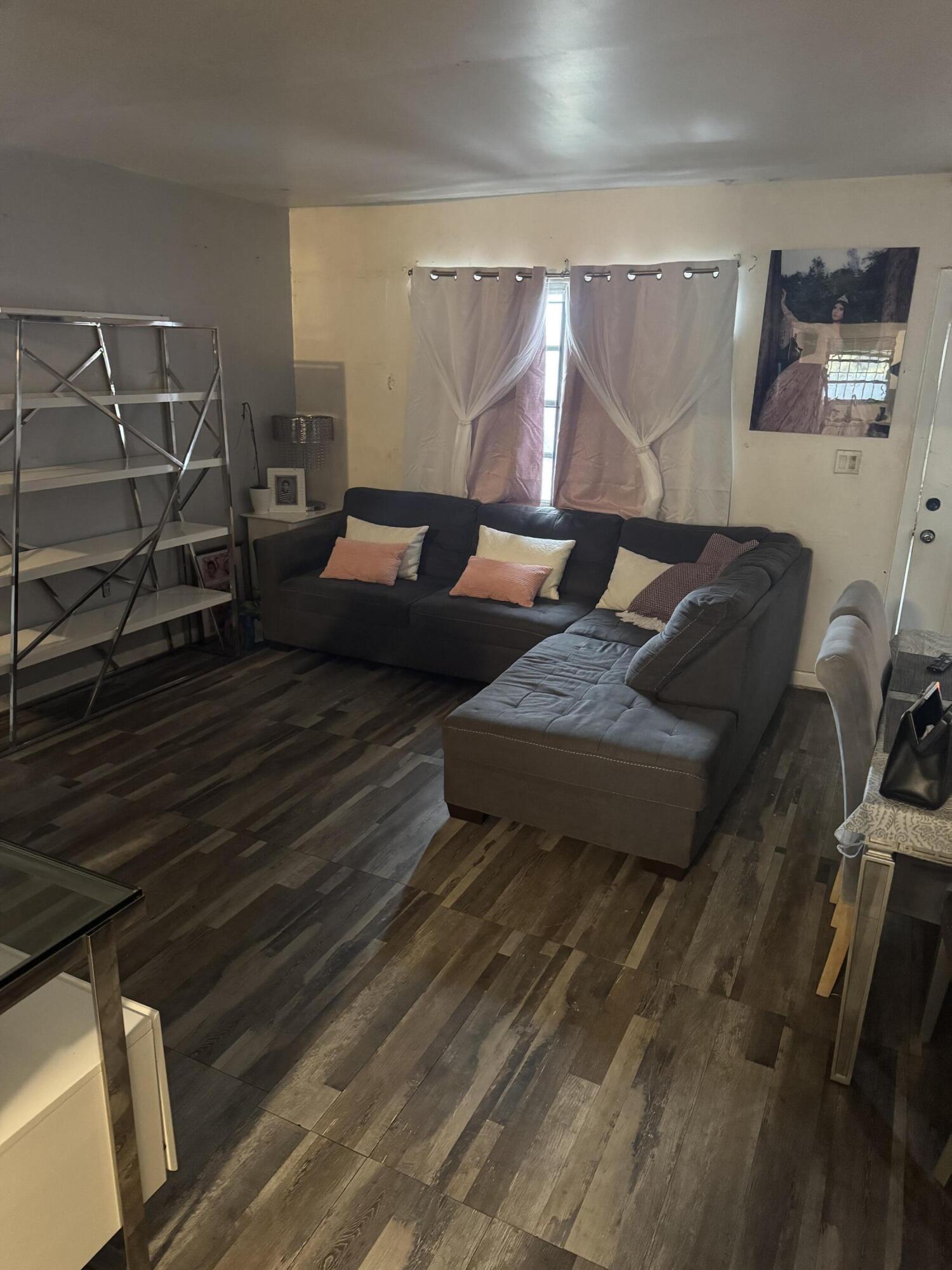 1017 Northwest 47th Street Miami, FL 33127 - Photo 4 of 18 a living room with furniture and a couch