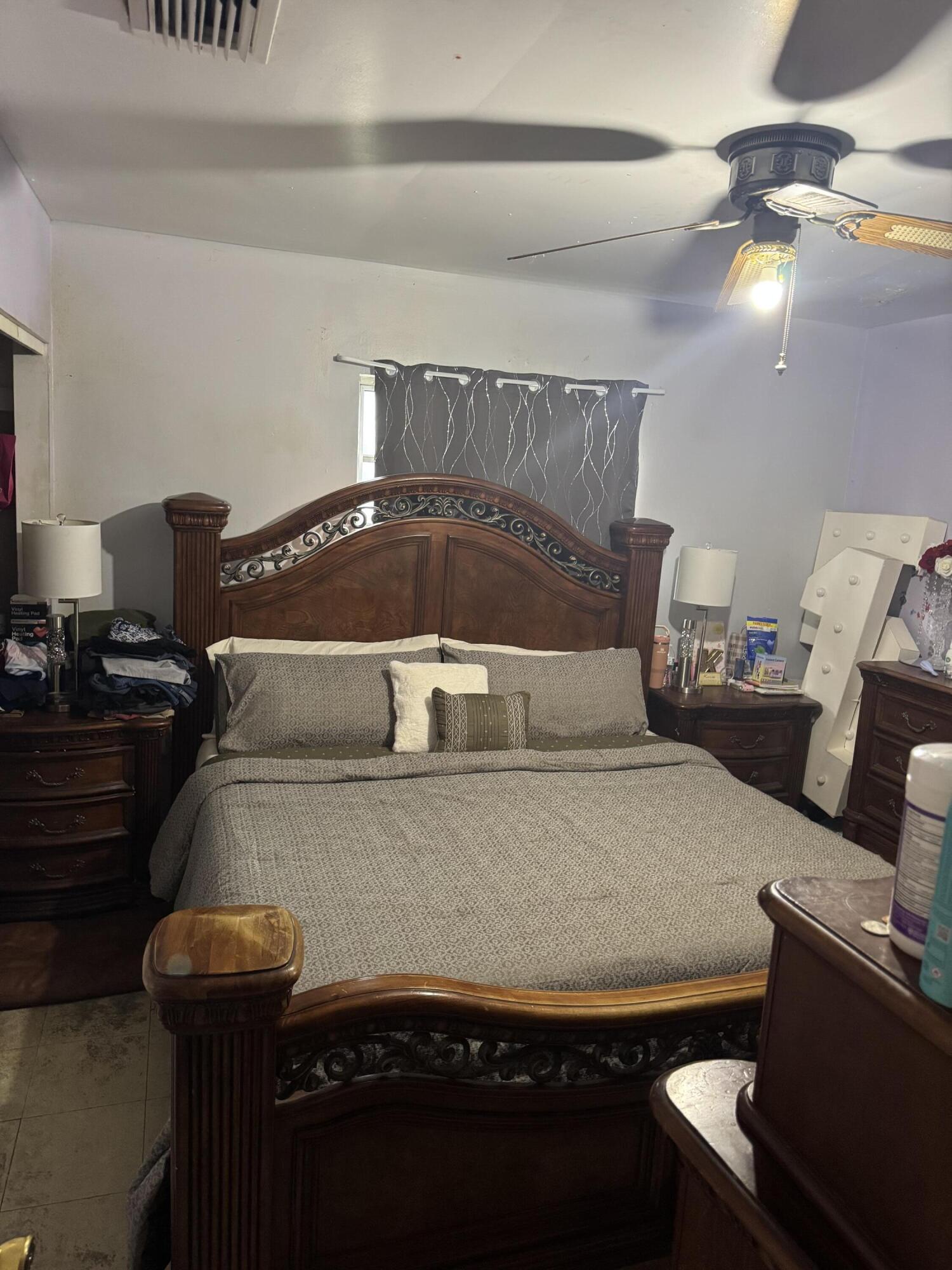 1017 Northwest 47th Street Miami, FL 33127 - Photo 6 of 18 a bedroom with a bed and a lamp with window