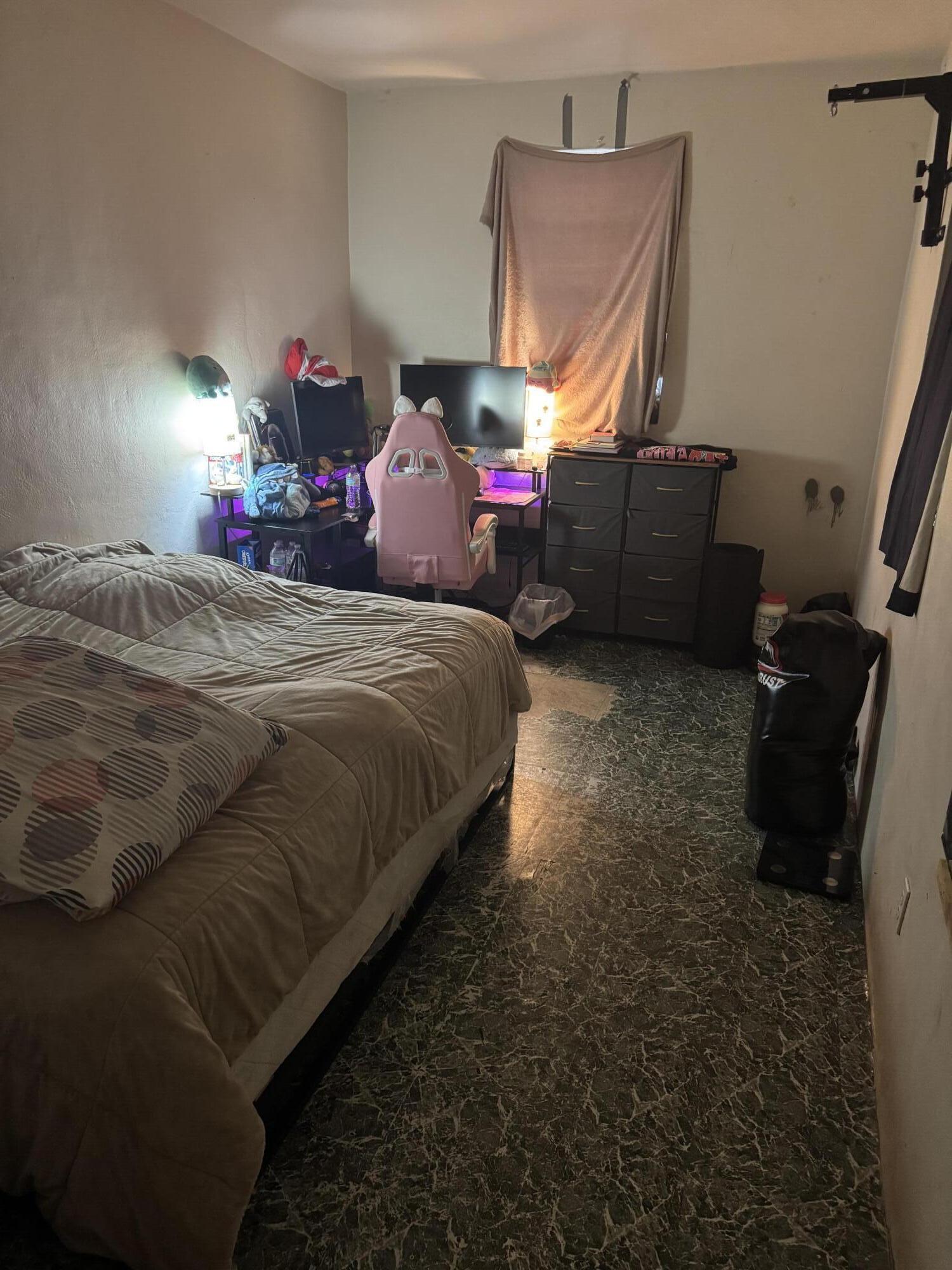 1017 Northwest 47th Street Miami, FL 33127 - Photo 8 of 18 a bed sitting in a room next to a window