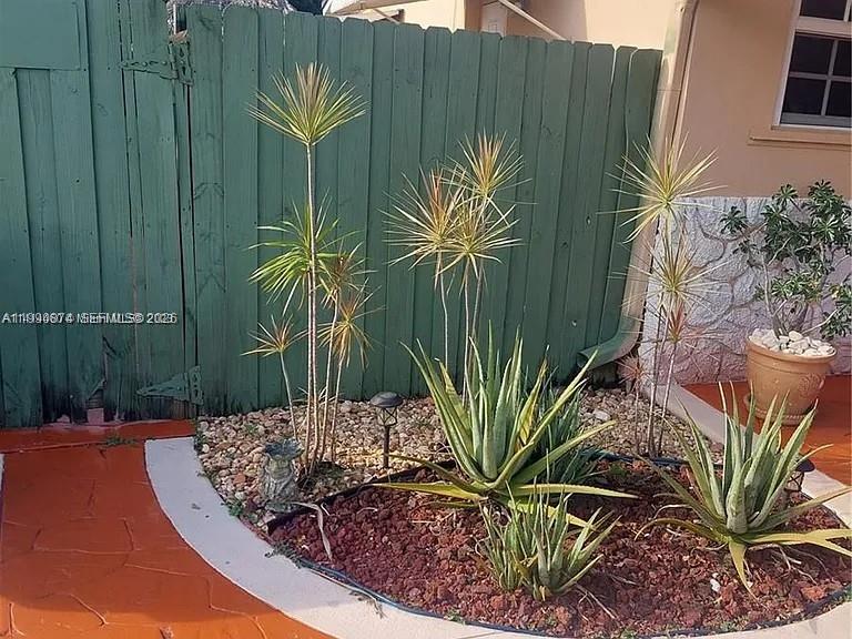 6117 Southwest 31st Street, Unit B Miramar, FL 33023 - Photo 1 of 8 a view of a backyard with plants