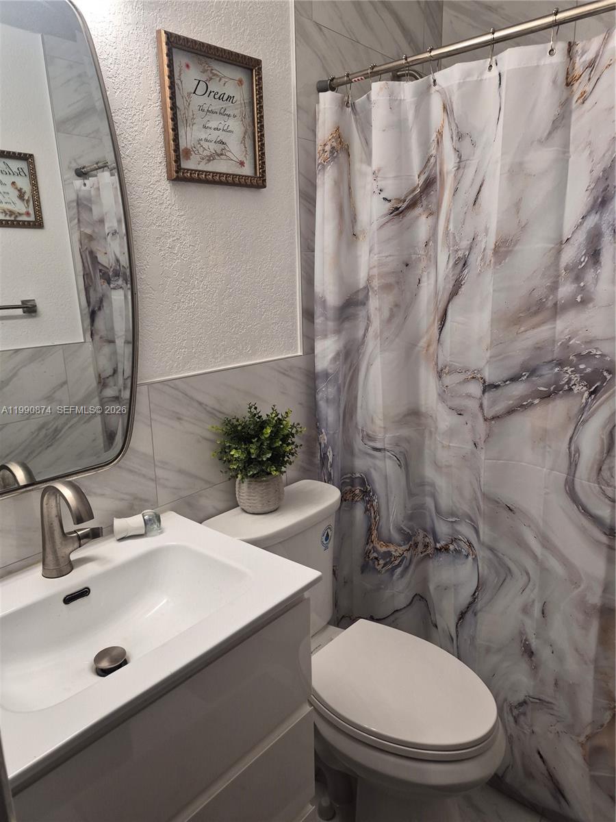 6117 Southwest 31st Street, Unit B Miramar, FL 33023 - Photo 8 of 8 a bathroom with a sink and toilet