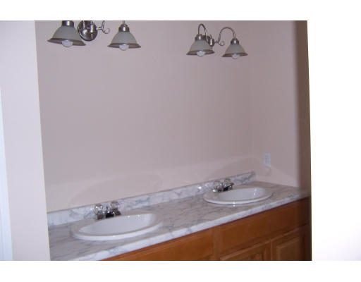 94 Lamont Street Springfield, MA 01119 - Photo 13 of 14 a bathroom with a sink vanity and a mirror