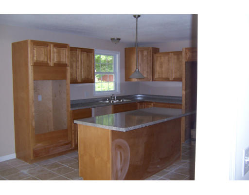 94 Lamont Street Springfield, MA 01119 - Photo 4 of 14 a kitchen with a sink a refrigerator and a mirror
