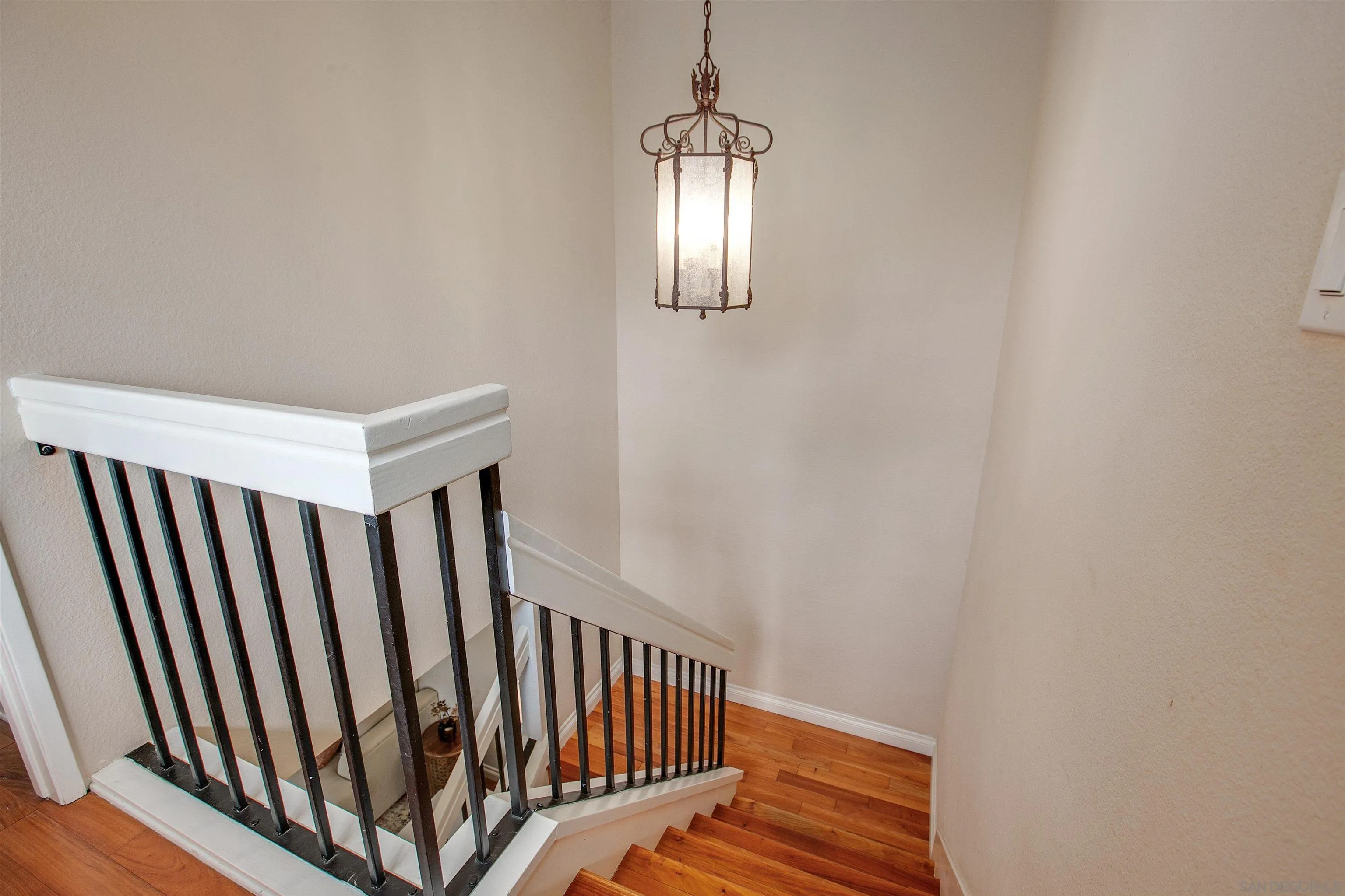 2952 Cape Cod Circle Carlsbad, CA 92010 - Photo 16 of 24 a view of staircase with railing and a chandelier
