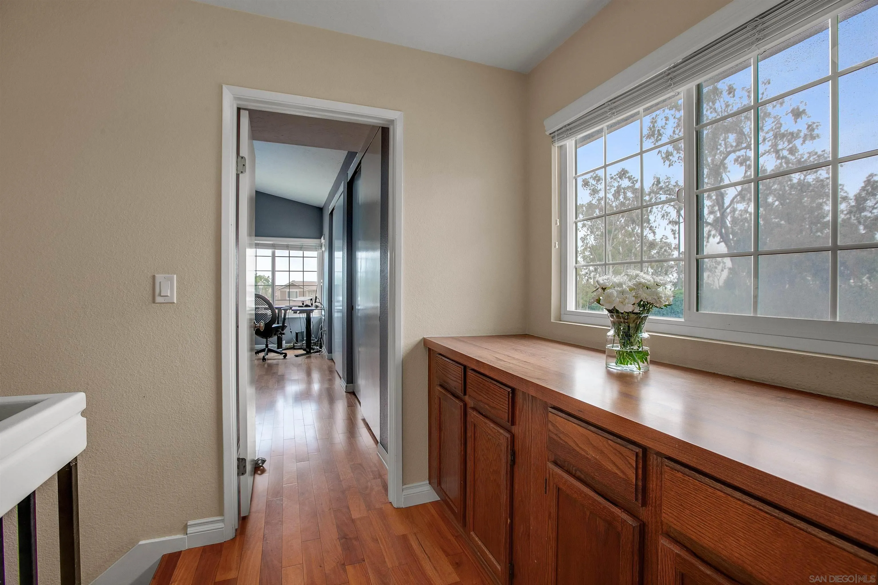 2952 Cape Cod Circle Carlsbad, CA 92010 - Photo 17 of 24 a hallway with sink and wooden floor