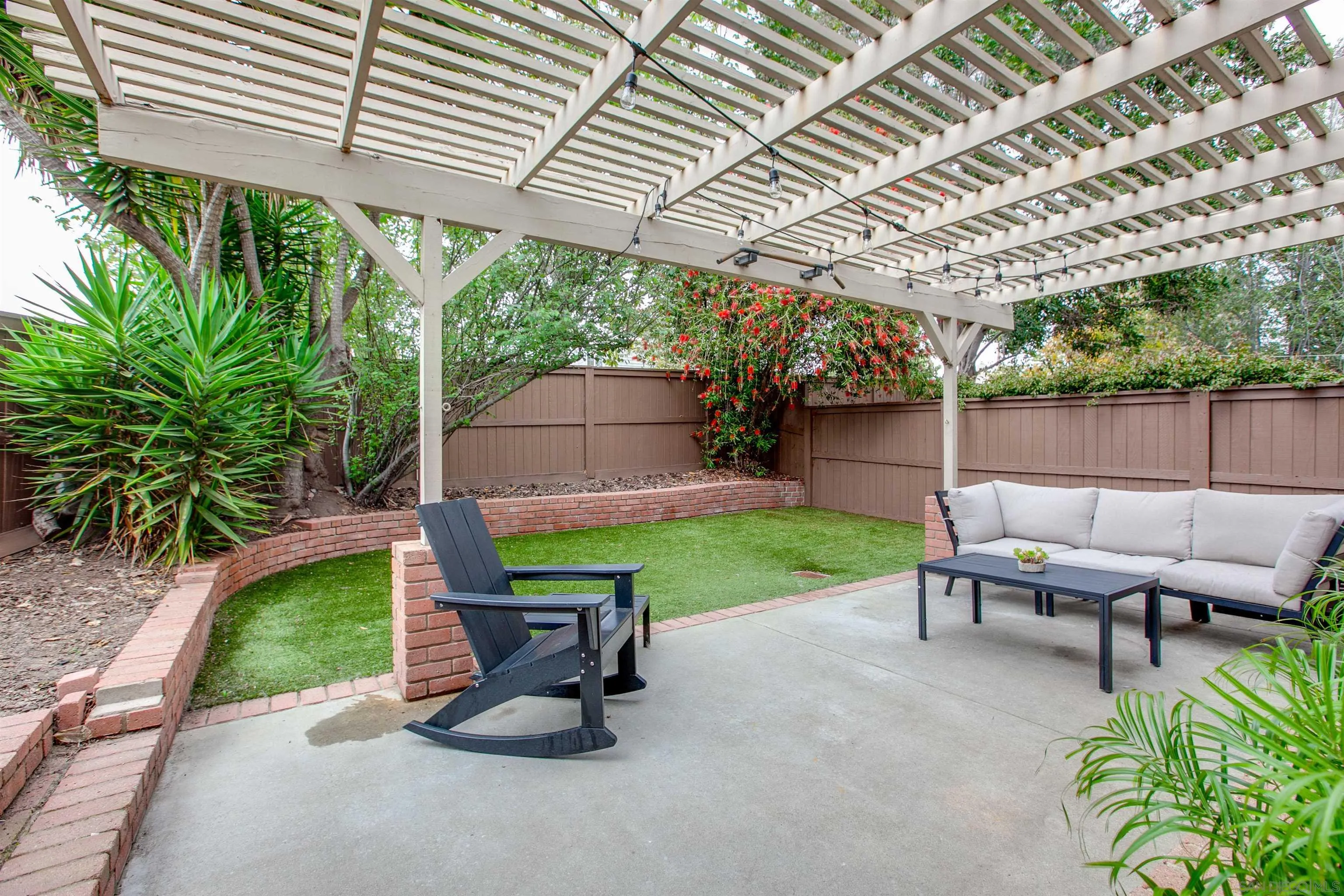 2952 Cape Cod Circle Carlsbad, CA 92010 - Photo 22 of 24 a view of a backyard with sitting area furniture and a garden