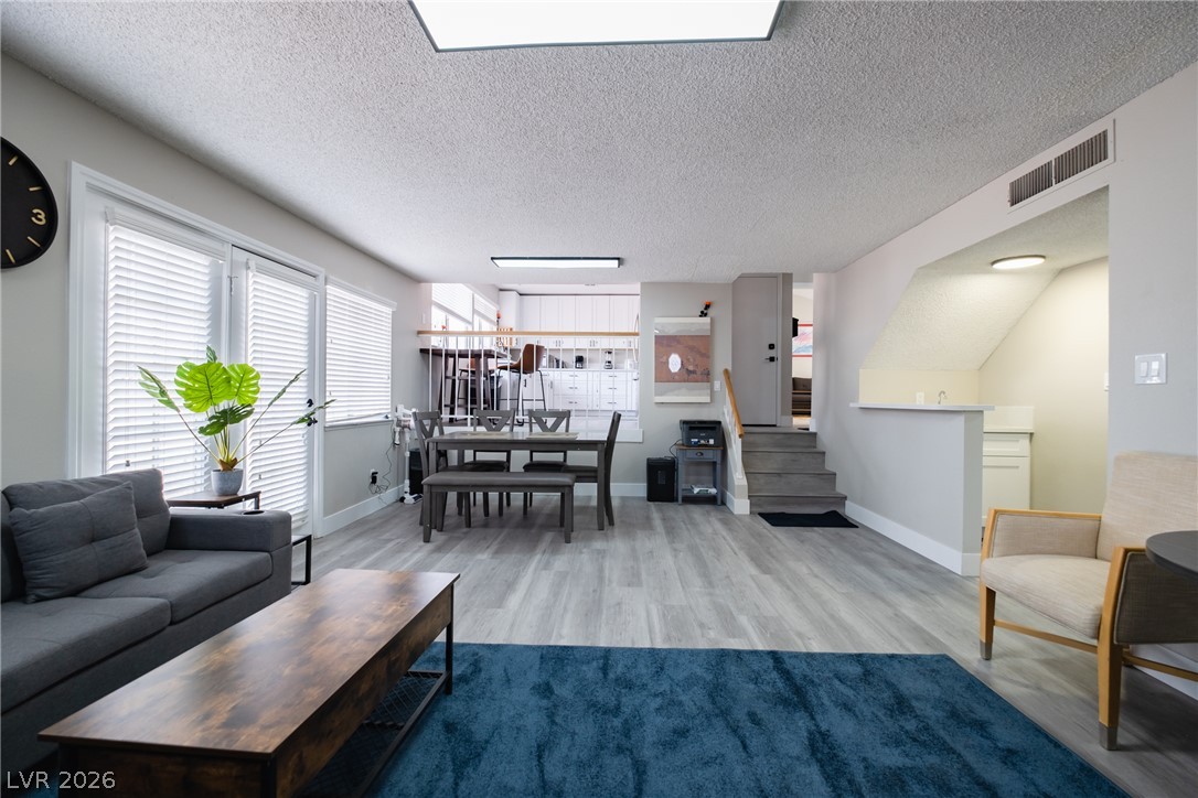 6356 West Viking Road Las Vegas, NV 89103 - Photo 11 of 51 Gleaming wood-look floors anchor a multi-level layout illuminated by abundant natural window light.