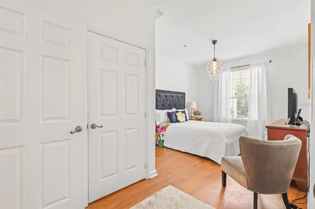 a bedroom with a bed and a chandelier