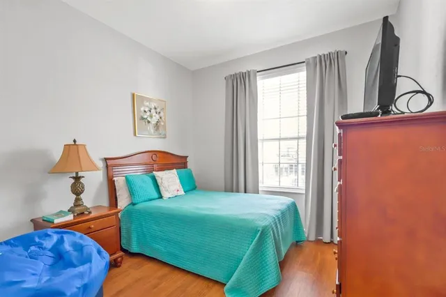 a bedroom with two beds and a potted plant