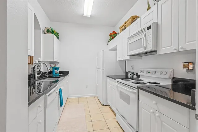 a white refrigerator freezer sitting in a kitchen