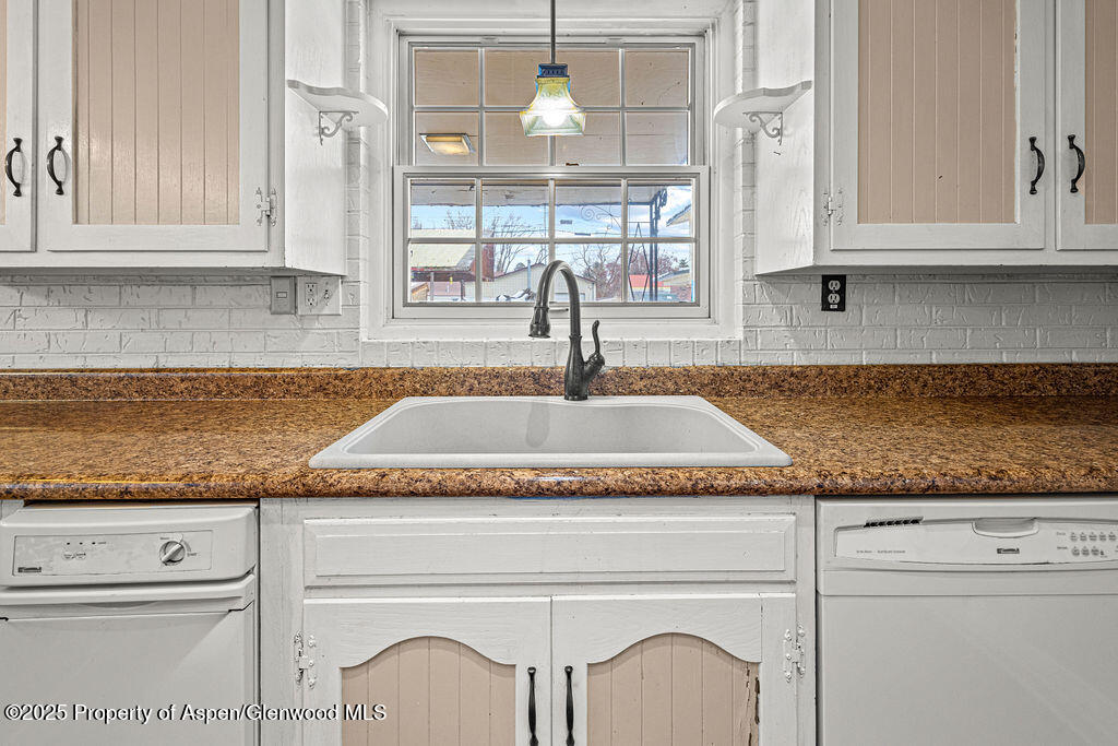 779 Taylor Street Craig, CO 81625 - Photo 36 of 84 a kitchen with granite countertop white cabinets and a granite counter tops