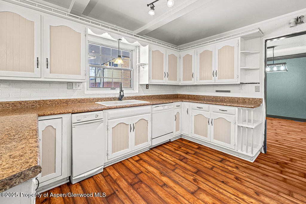 779 Taylor Street Craig, CO 81625 - Photo 49 of 84 a kitchen with stainless steel appliances granite countertop a sink cabinets and wooden floor