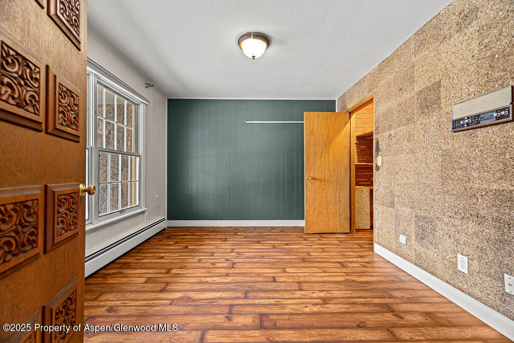 779 Taylor Street Craig, CO 81625 - Photo 69 of 84 a view of an empty room with window and wooden floor
