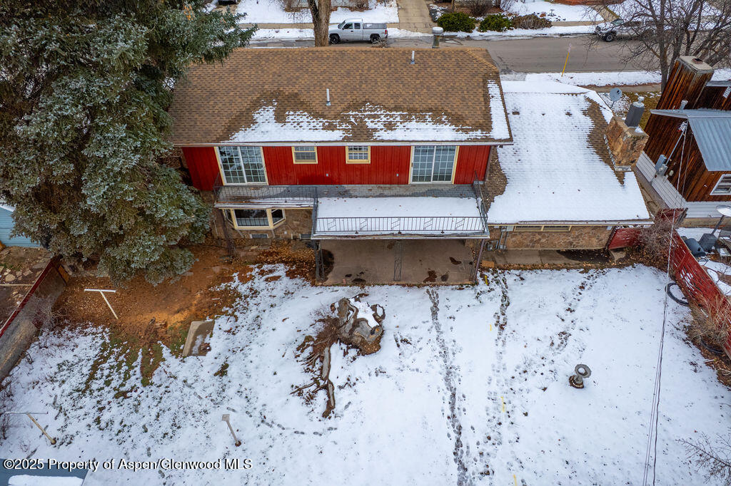 779 Taylor Street Craig, CO 81625 - Photo 9 of 84 an aerial view of a house with a yard covered with snow
