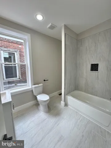 a bathroom with a toilet a sink and bathtub