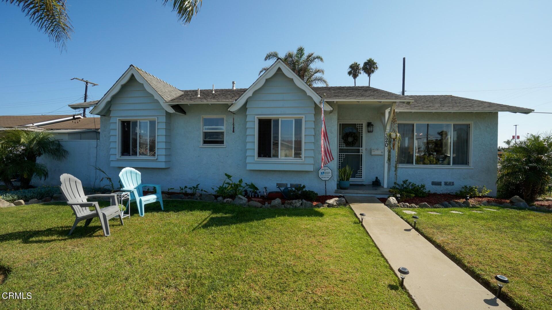 320 West Bard Road Oxnard, CA 93033 - Photo 2 of 21 a view of house with backyard and outdoor seating
