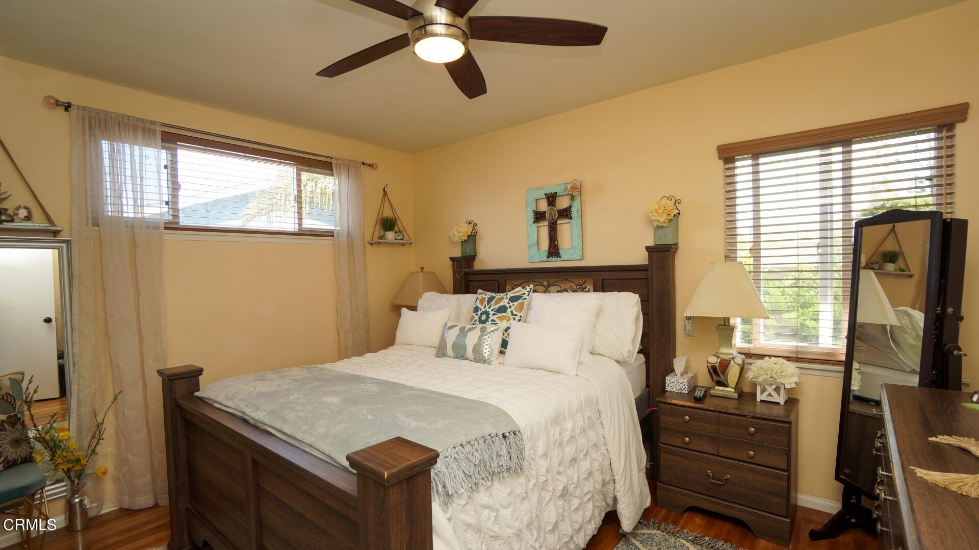 320 West Bard Road Oxnard, CA 93033 - Photo 11 of 21 a bedroom with a bed and wooden floor