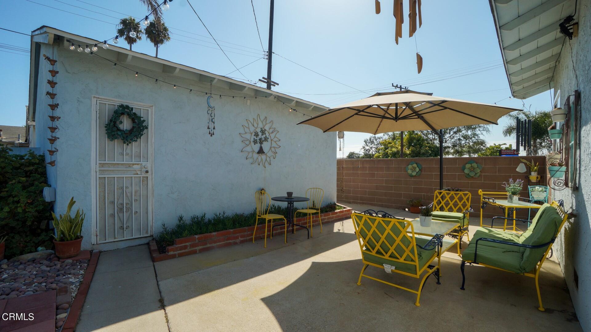 320 West Bard Road Oxnard, CA 93033 - Photo 17 of 21 a patio with a patio table and chairs