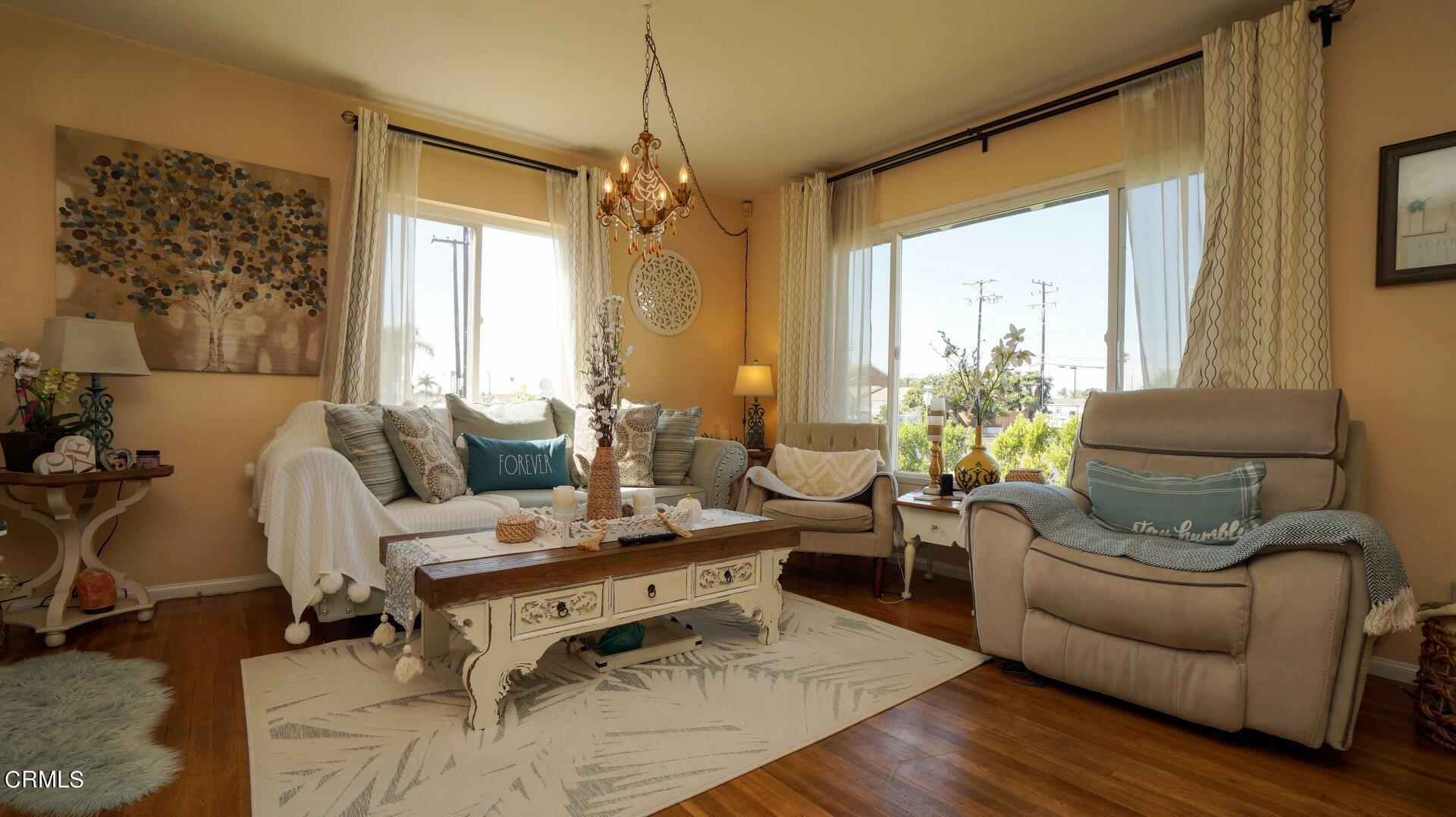 320 West Bard Road Oxnard, CA 93033 - Photo 5 of 21 a living room with furniture and a chandelier