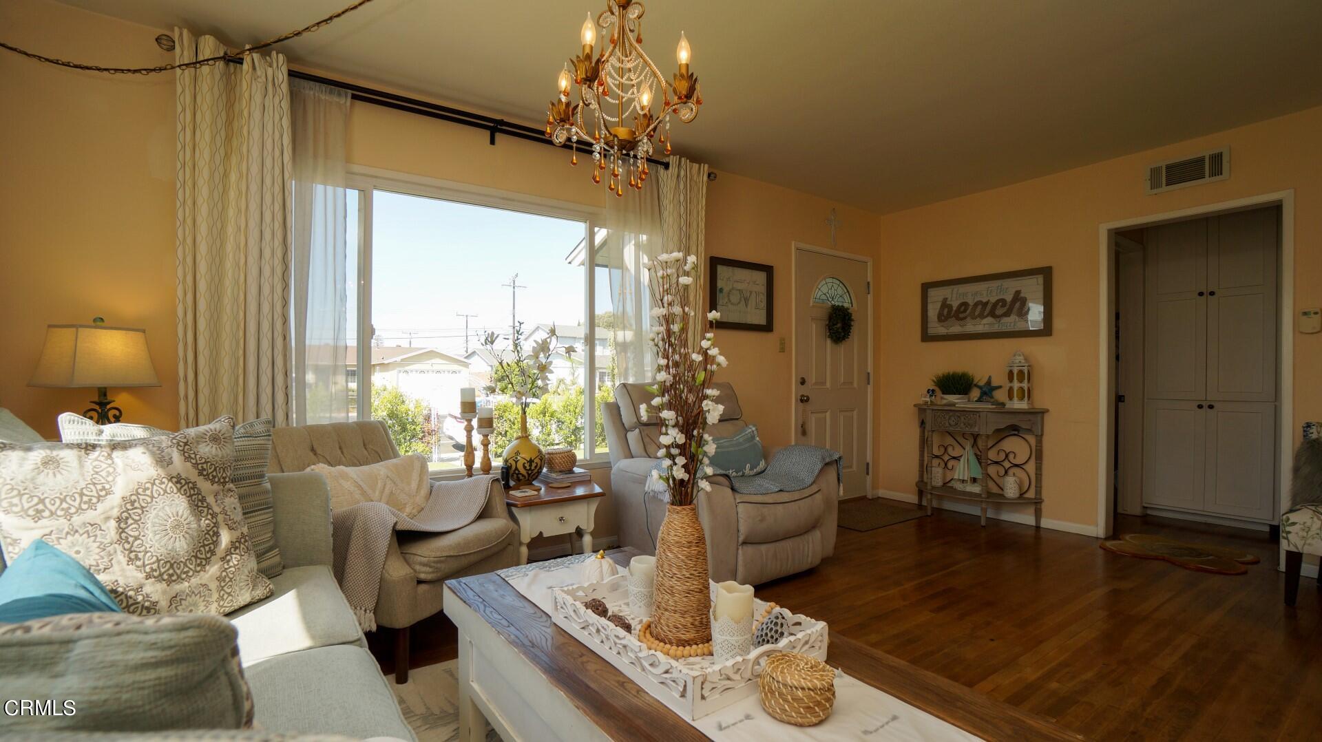 320 West Bard Road Oxnard, CA 93033 - Photo 6 of 21 a living room with furniture and a chandelier