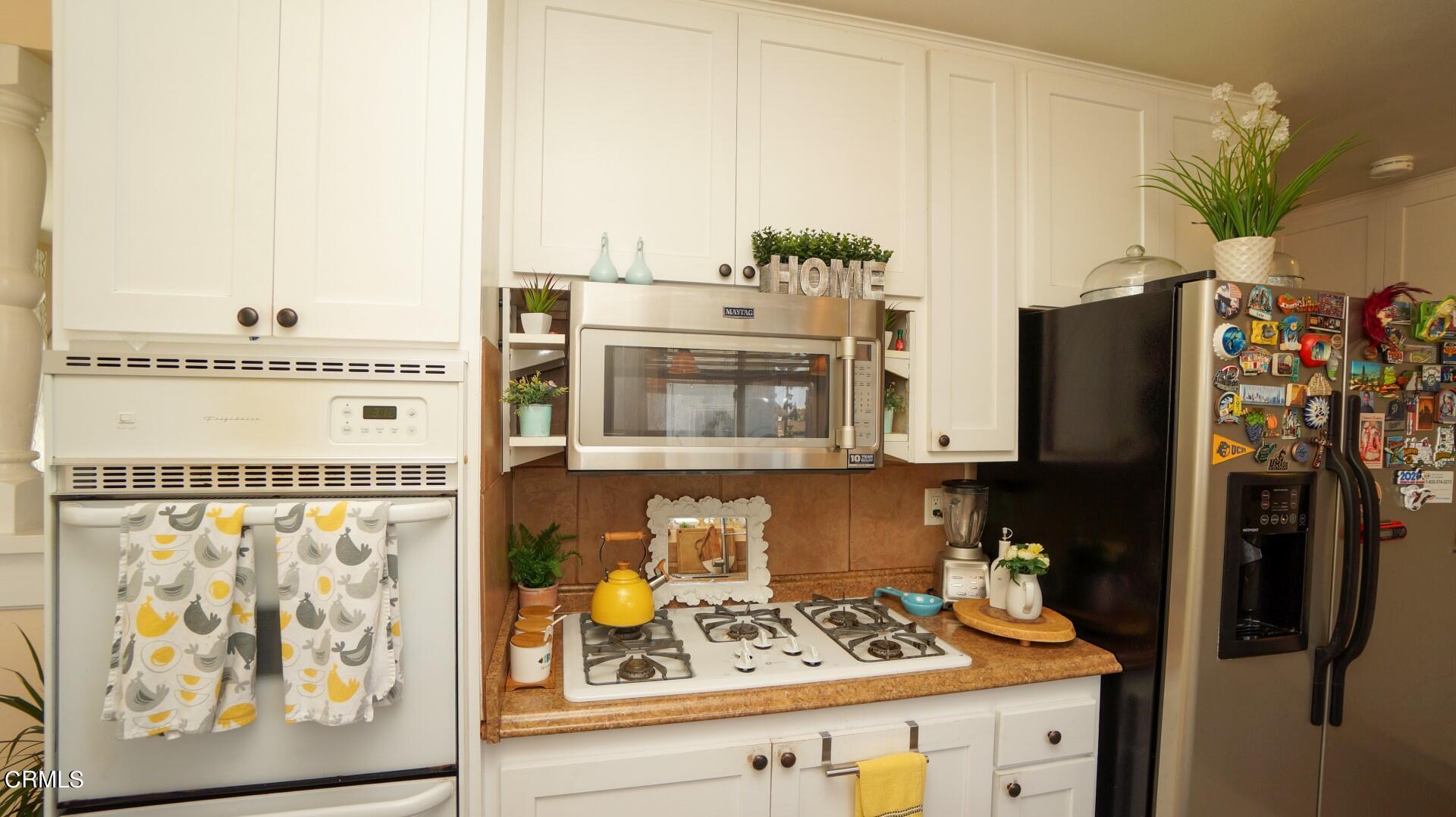 320 West Bard Road Oxnard, CA 93033 - Photo 10 of 21 a kitchen with stainless steel appliances granite countertop a refrigerator and a stove
