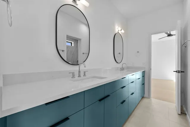a bathroom with a double vanity sink and a mirror