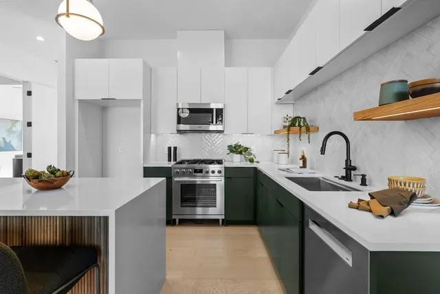 a kitchen with stainless steel appliances a sink and a stove