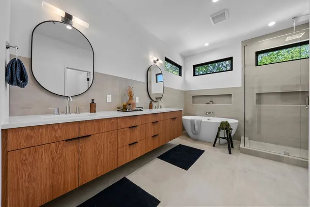 a bathroom with a double vanity sink and a mirror
