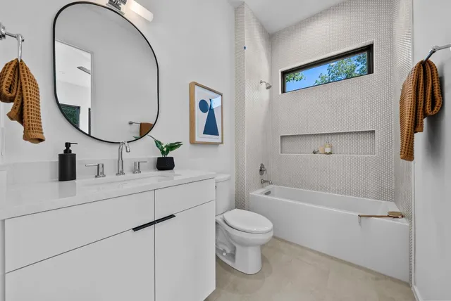 a bathroom with a toilet sink and mirror