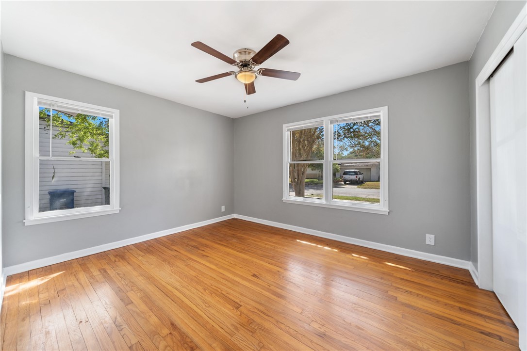 826 Rosedale Drive Corpus Christi, TX 78411 - Photo 15 of 22 a view of an empty room with wooden floor and a window