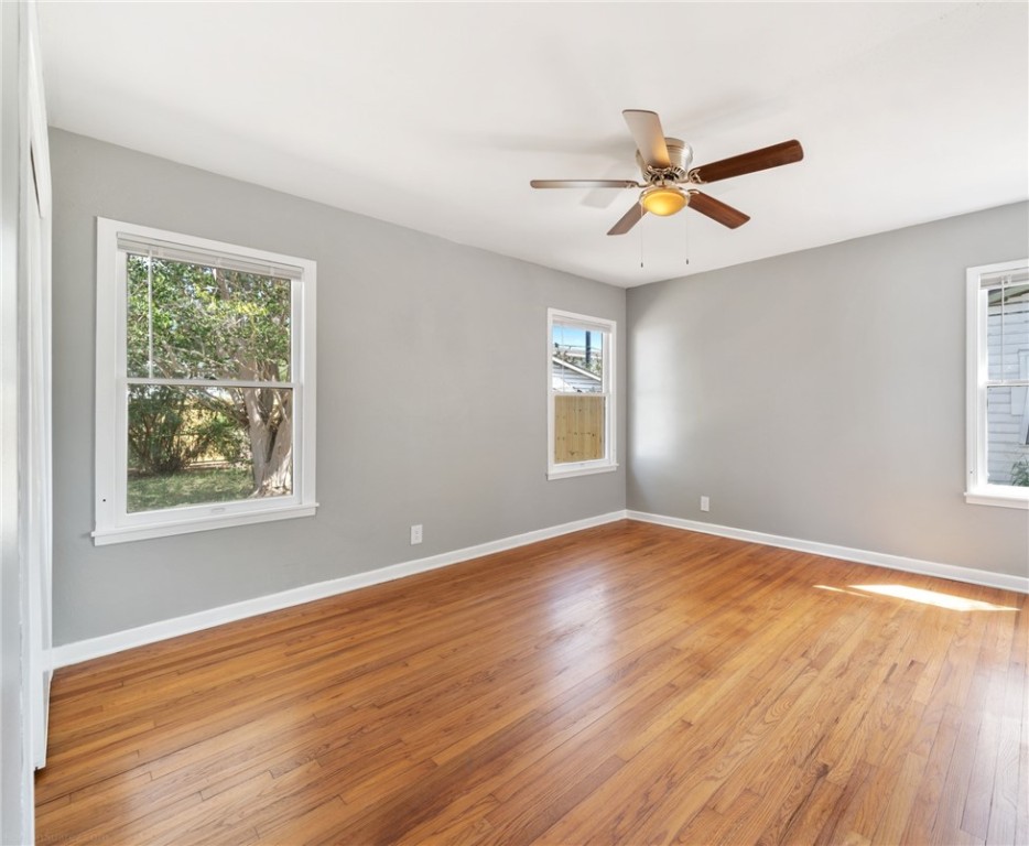 826 Rosedale Drive Corpus Christi, TX 78411 - Photo 16 of 22 a view of an empty room with window and wooden floor