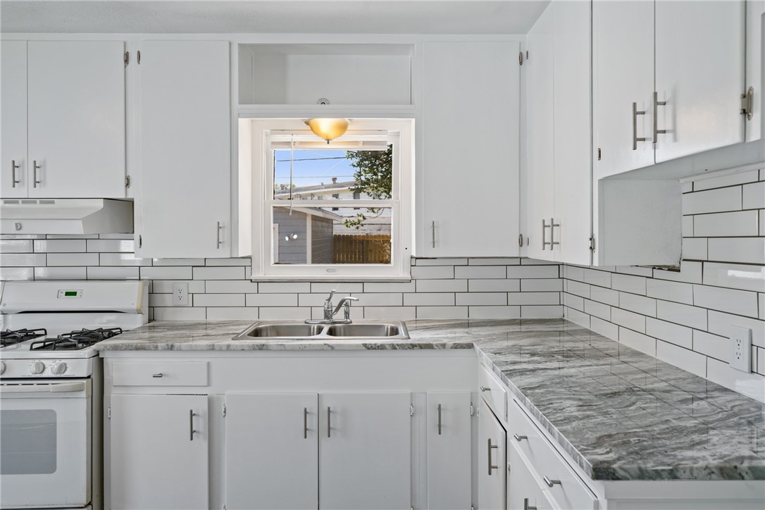 826 Rosedale Drive Corpus Christi, TX 78411 - Photo 9 of 22 a kitchen with stainless steel appliances granite countertop a sink stove and cabinets