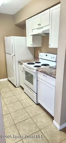 a kitchen with a stove and a refrigerator