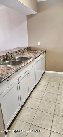 a view of a kitchen with granite countertop cabinets and a stove top oven