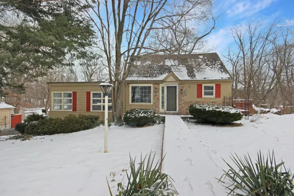 a view of house with a yard covered in snow