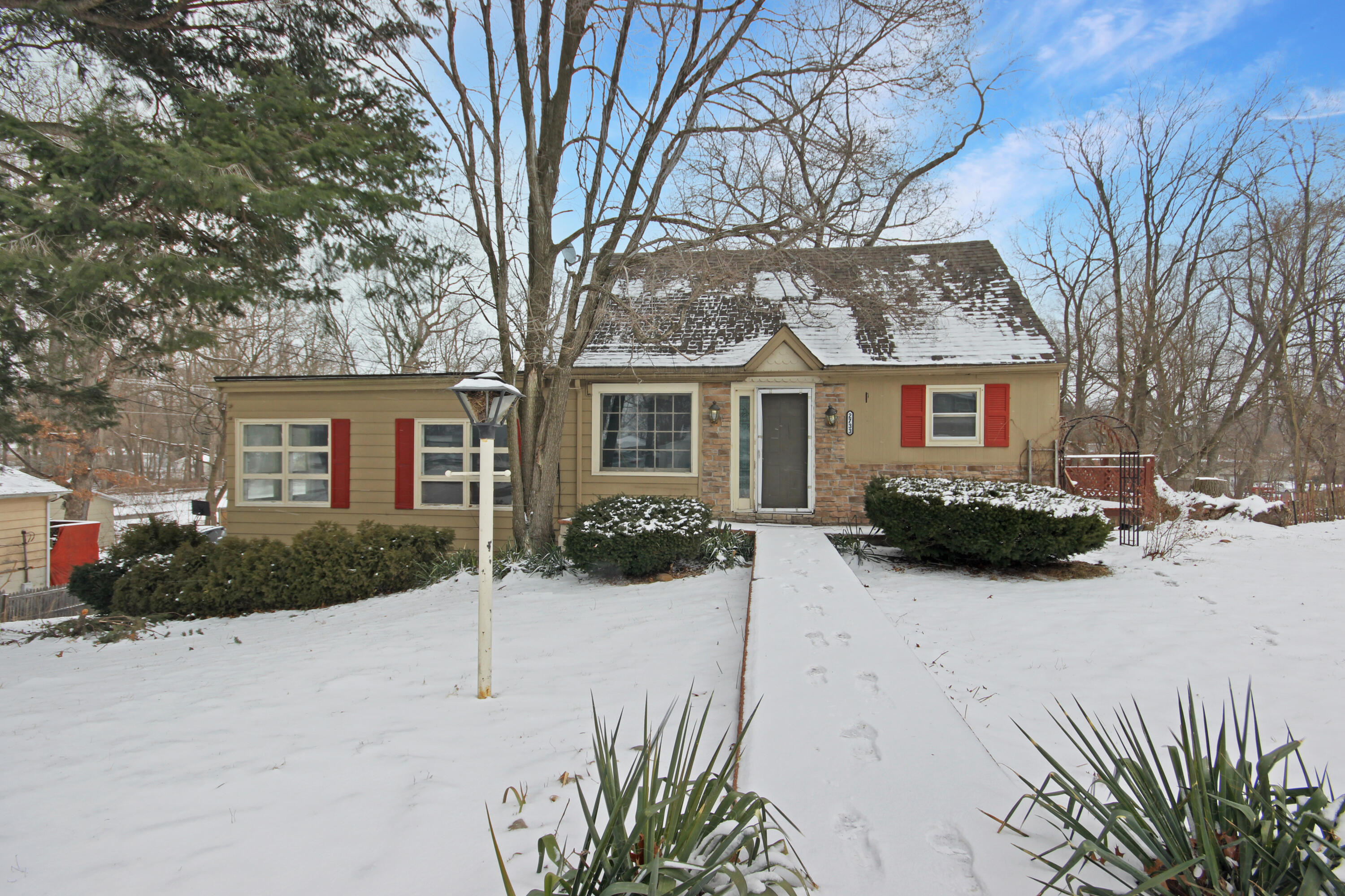 2733 Locust Street Portage, IN 46368 - Photo 2 of 20 a view of house with a yard covered in snow