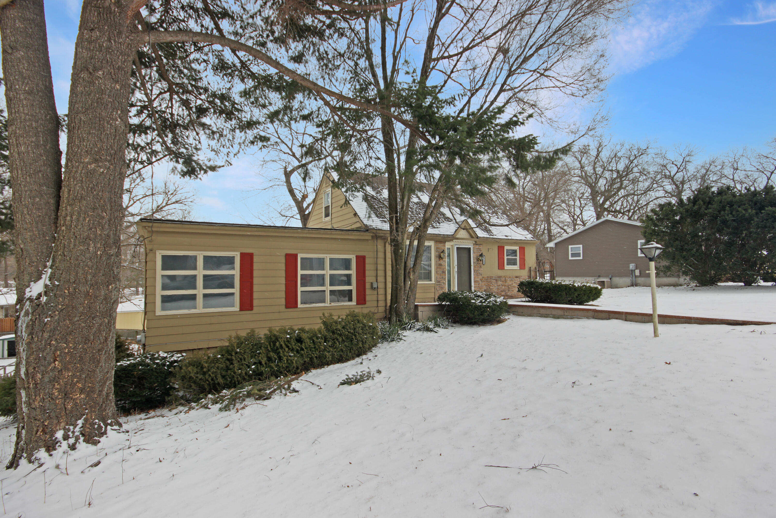 2733 Locust Street Portage, IN 46368 - Photo 3 of 20 a front view of a house with a yard covered in snow