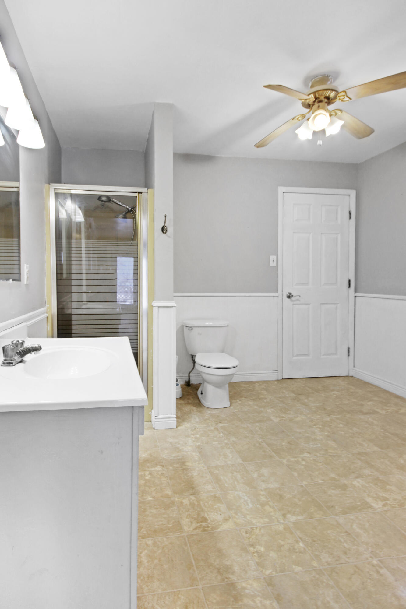 2733 Locust Street Portage, IN 46368 - Photo 8 of 20 a bathroom with a sink a toilet and shower