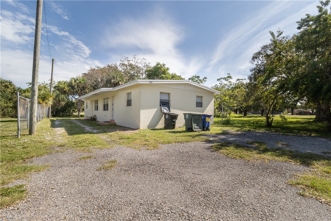 708 North 14th Street Fort Pierce, FL 34950 - Photo 1 of 12 a view of a house with backyard and trees