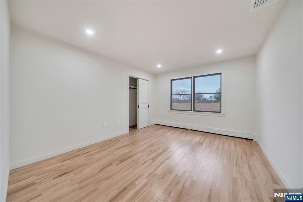 468 Morse Avenue Ridgefield, NJ 07657 - Photo 32 of 48 an empty room with wooden floor and windows