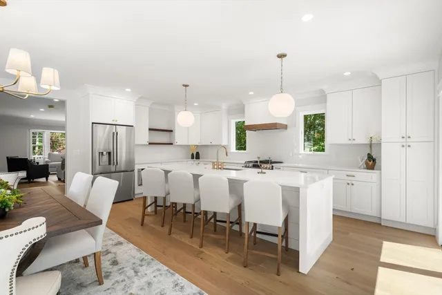a view of a dining room with furniture a chandelier and wooden floor