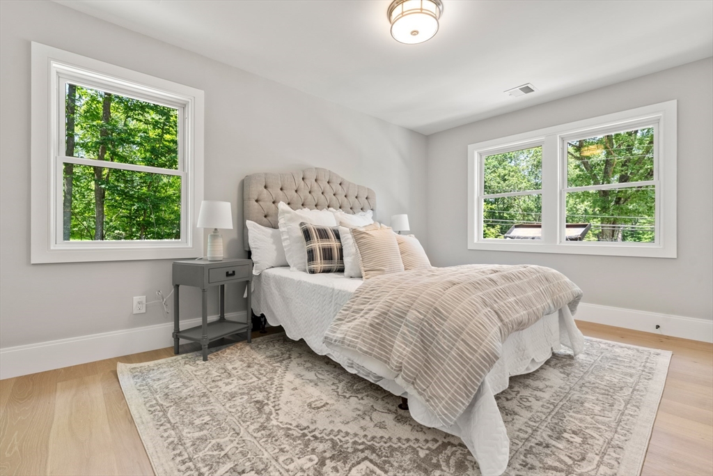 2 Rockwood Road Natick, MA 01760 - Photo 16 of 37 a bed sitting in a bedroom next to a window