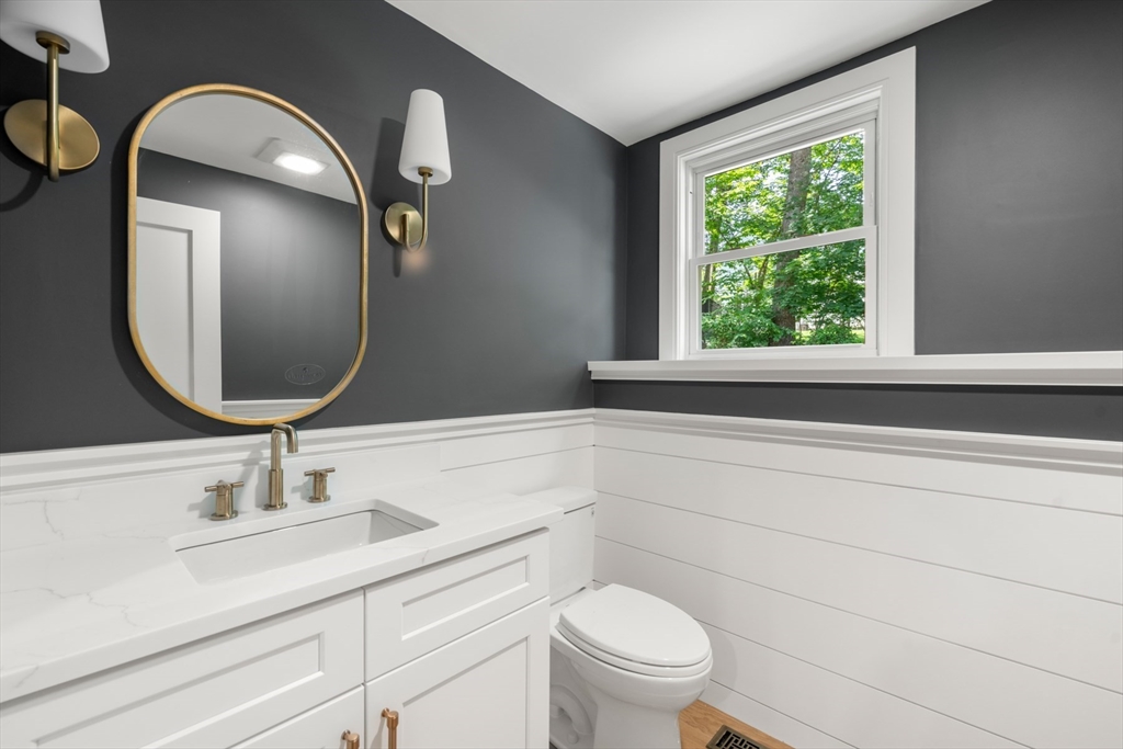 2 Rockwood Road Natick, MA 01760 - Photo 29 of 37 a bathroom with a toilet a sink and mirror